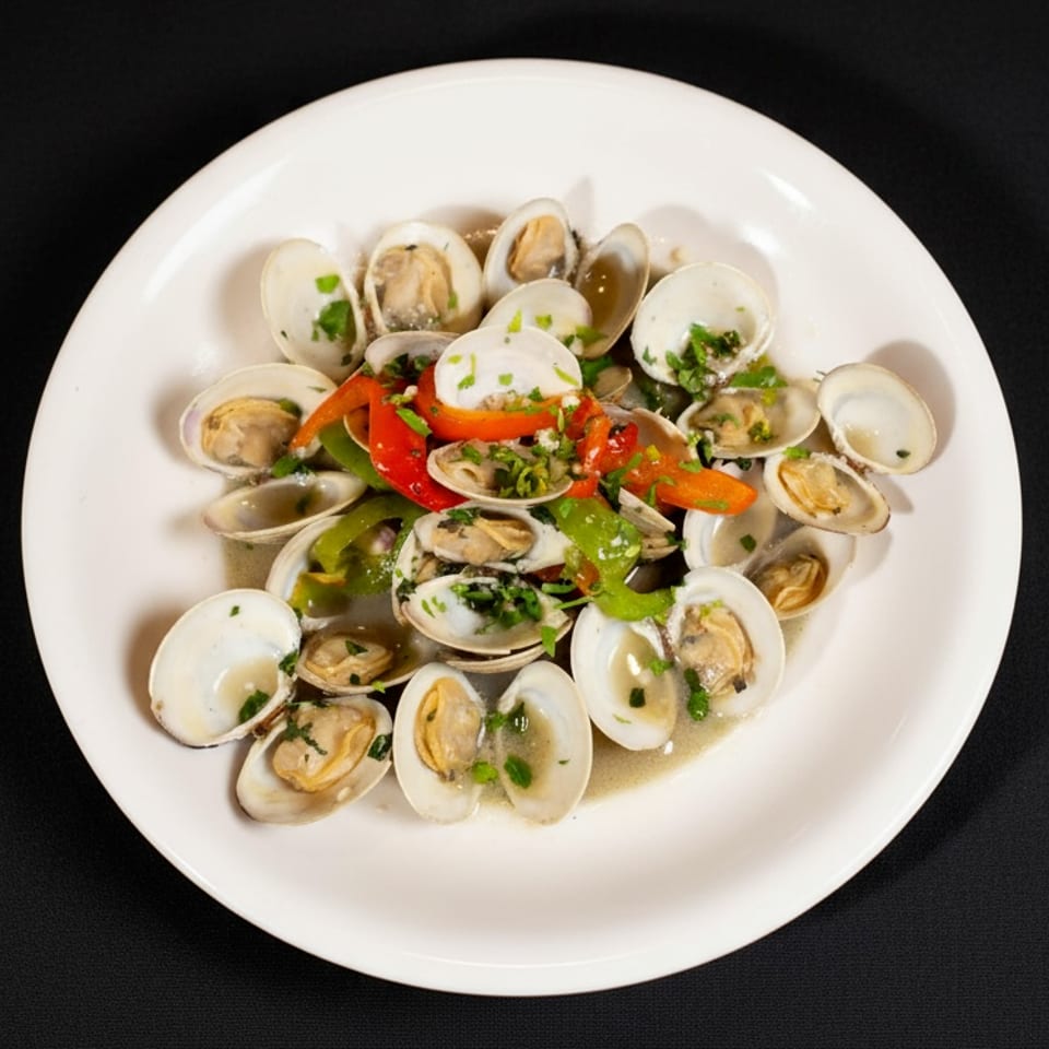 Plate of steamed clams with colorful bell peppers, herbs, and light broth on a white dish.